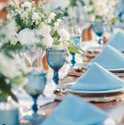 wedding table with blue glasswear and white flowers