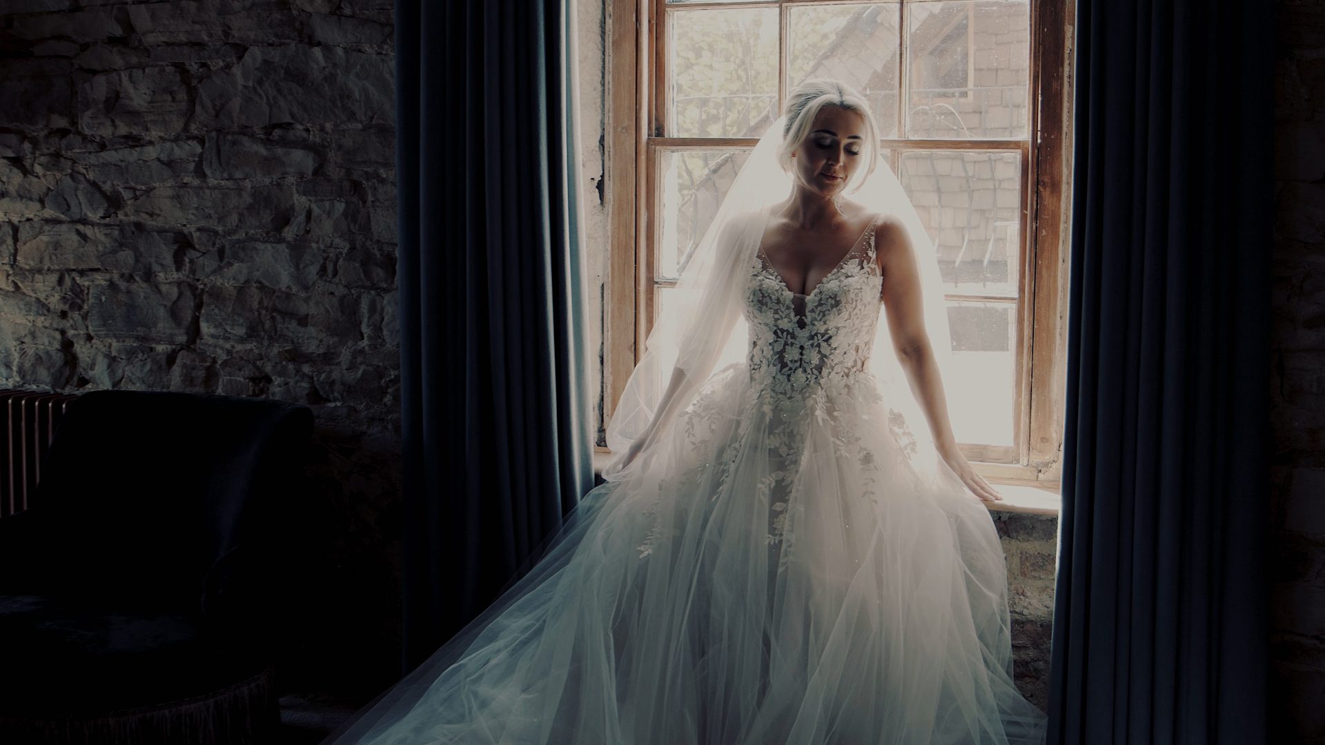 bride by window in dark room