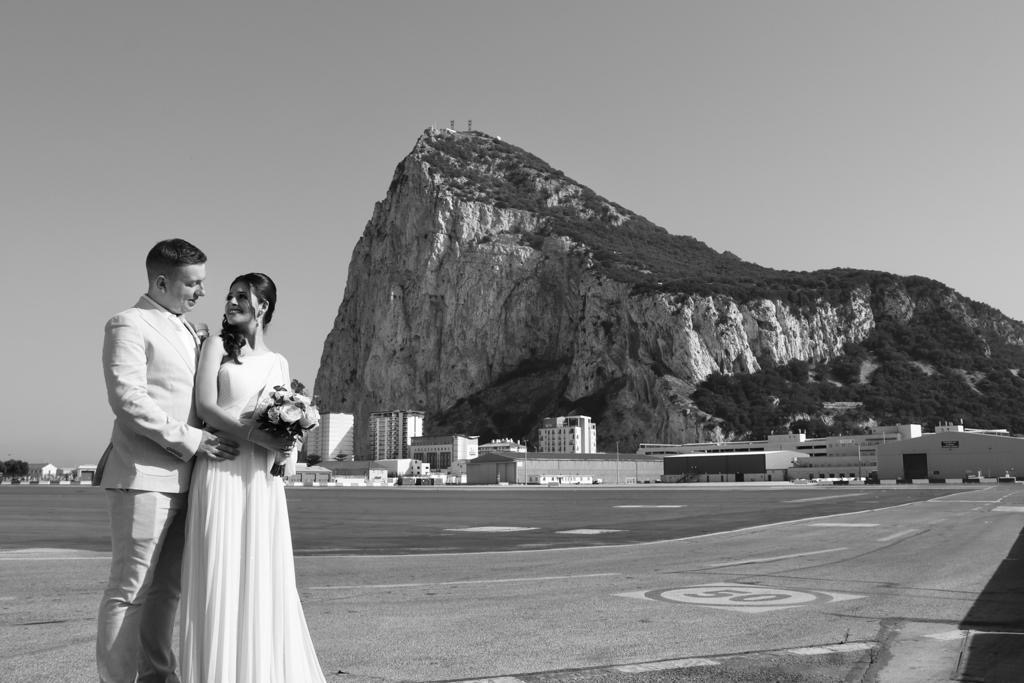 bride and groom with the Rock of Gibraltar in the background