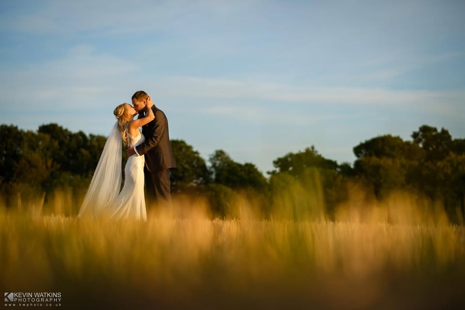 bride and groom in field