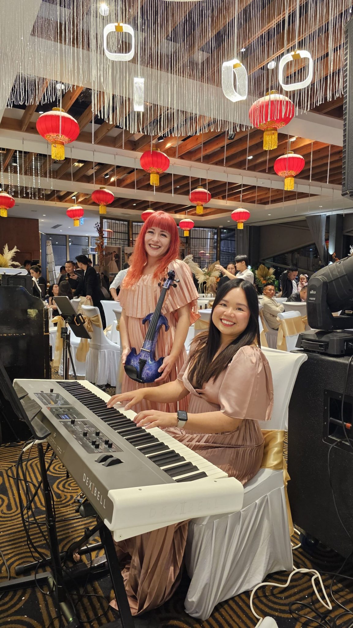 Violinist and pianist performing at a wedding ceremony.