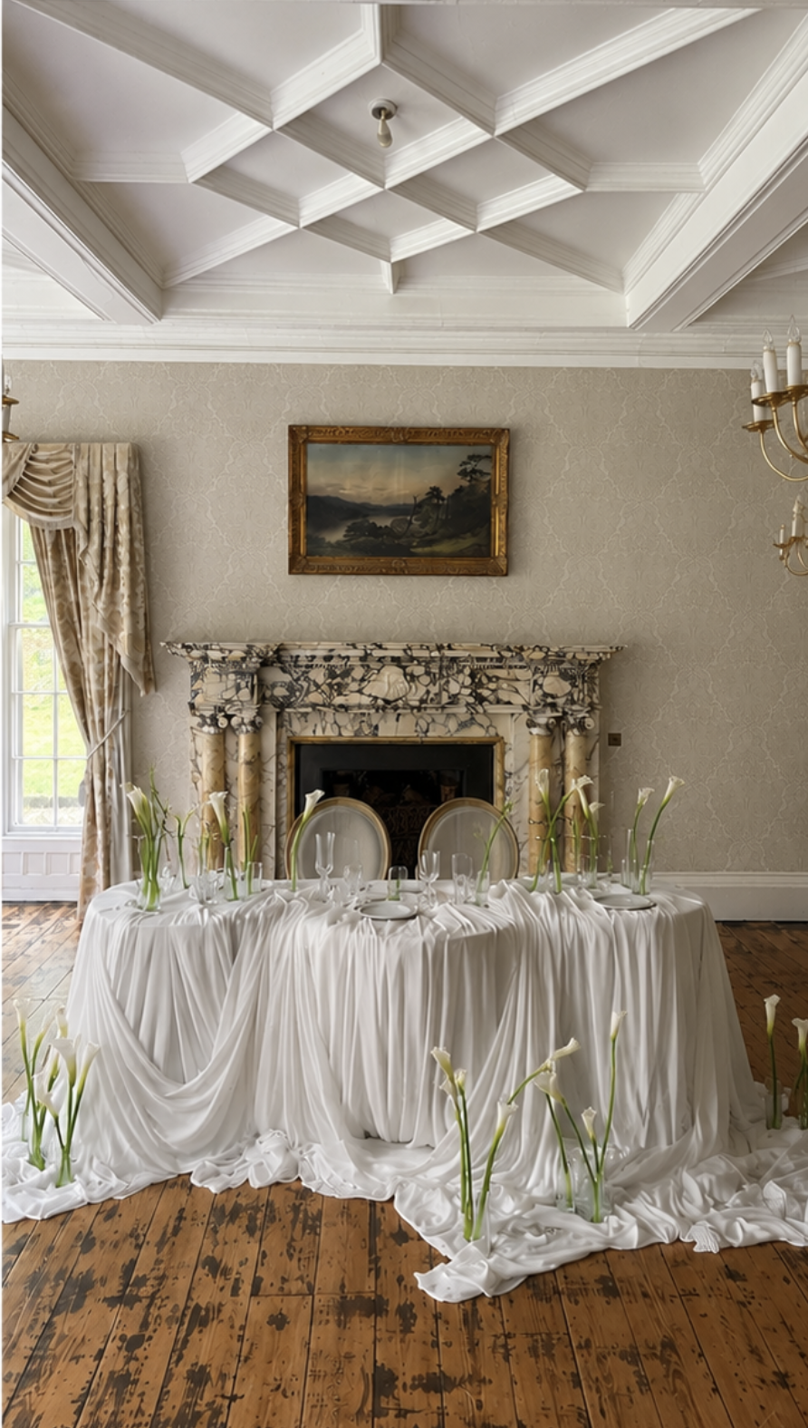Wedding table draped in white linen in front of a marble fireplace in a sunny room