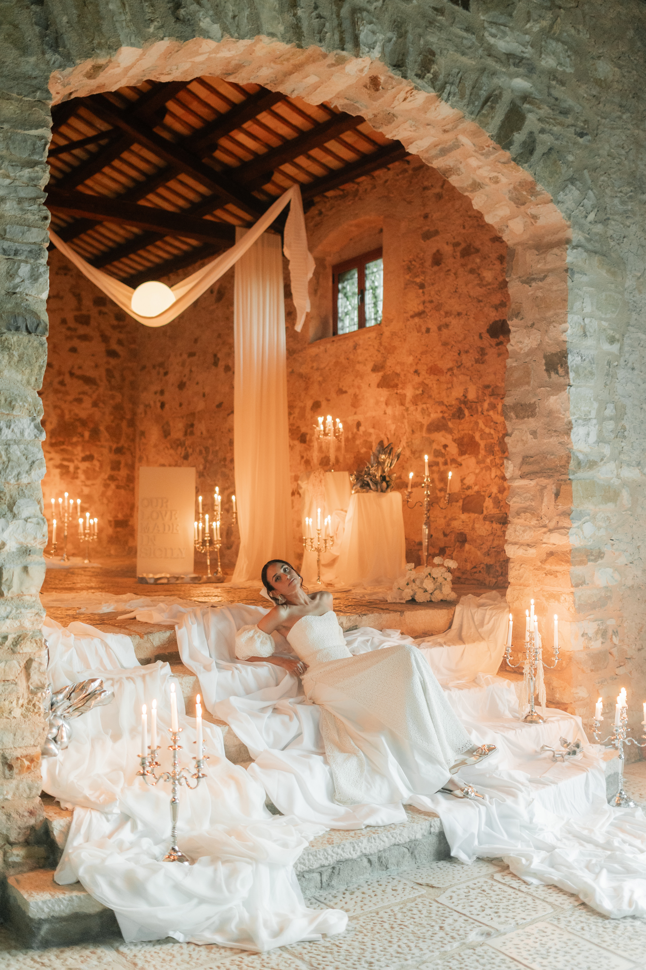 Luxury wedding design featuring candlelight, bridal fashion and elegant styling in a historic Sicilian venue.