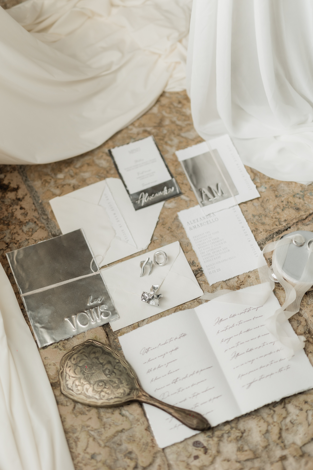 Luxury wedding stationery for a destination wedding in Sicily featuring bespoke invitations, silver foil details and bridal accessories.