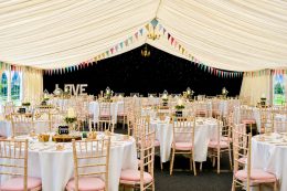 Elegant clearspan wedding marquee lit with soft lighting for a romantic daytime reception in York, North Yorkshire.