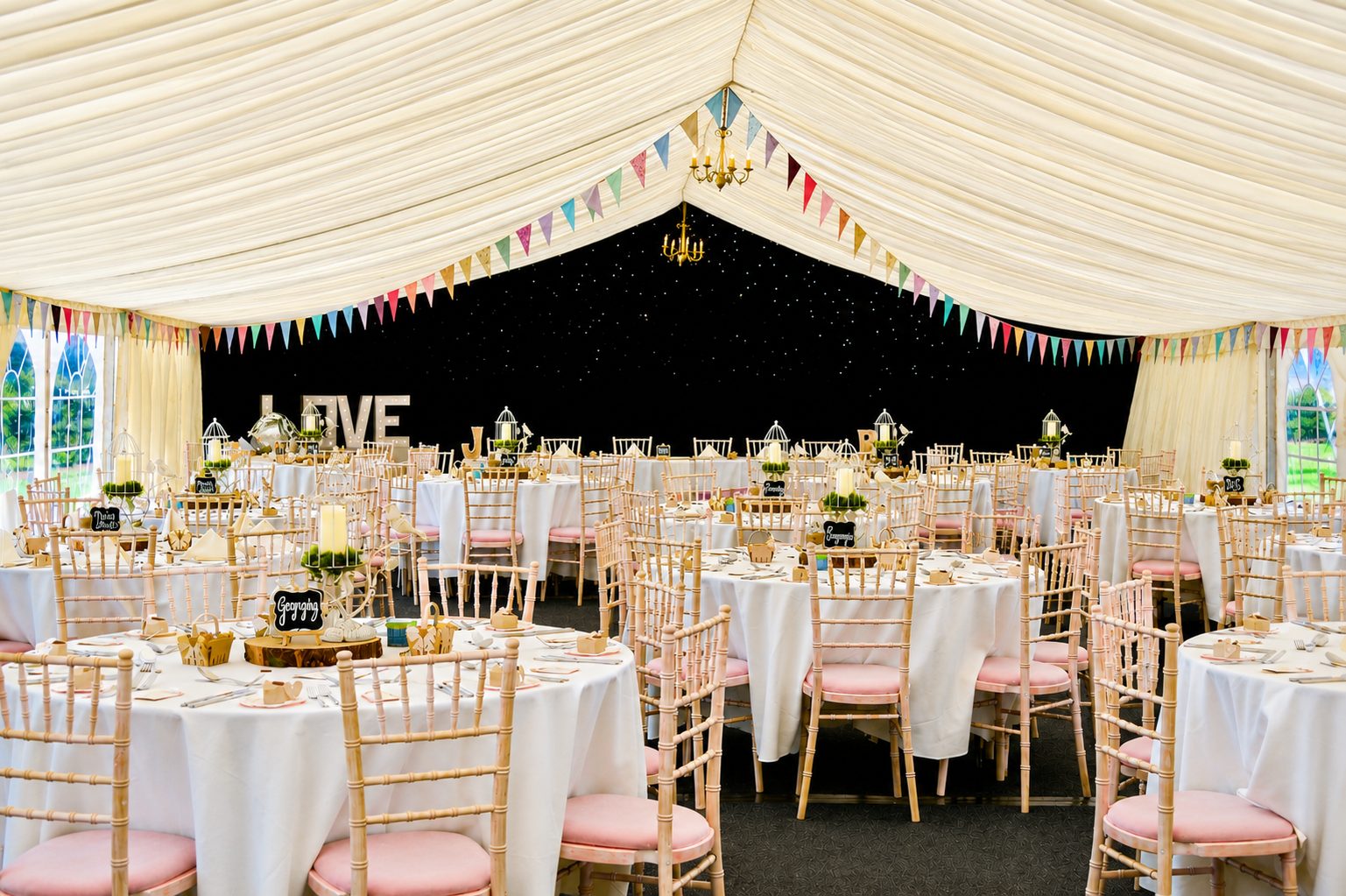Elegant clearspan wedding marquee lit with soft lighting for a romantic daytime reception in York, North Yorkshire.