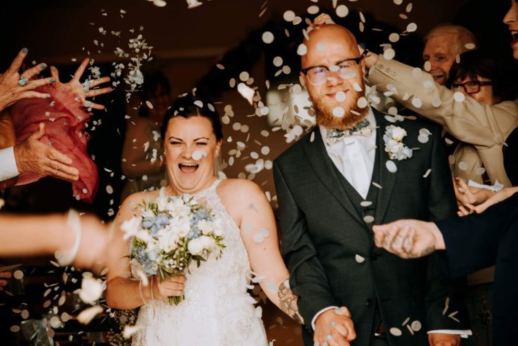 couple with confetti after wedding