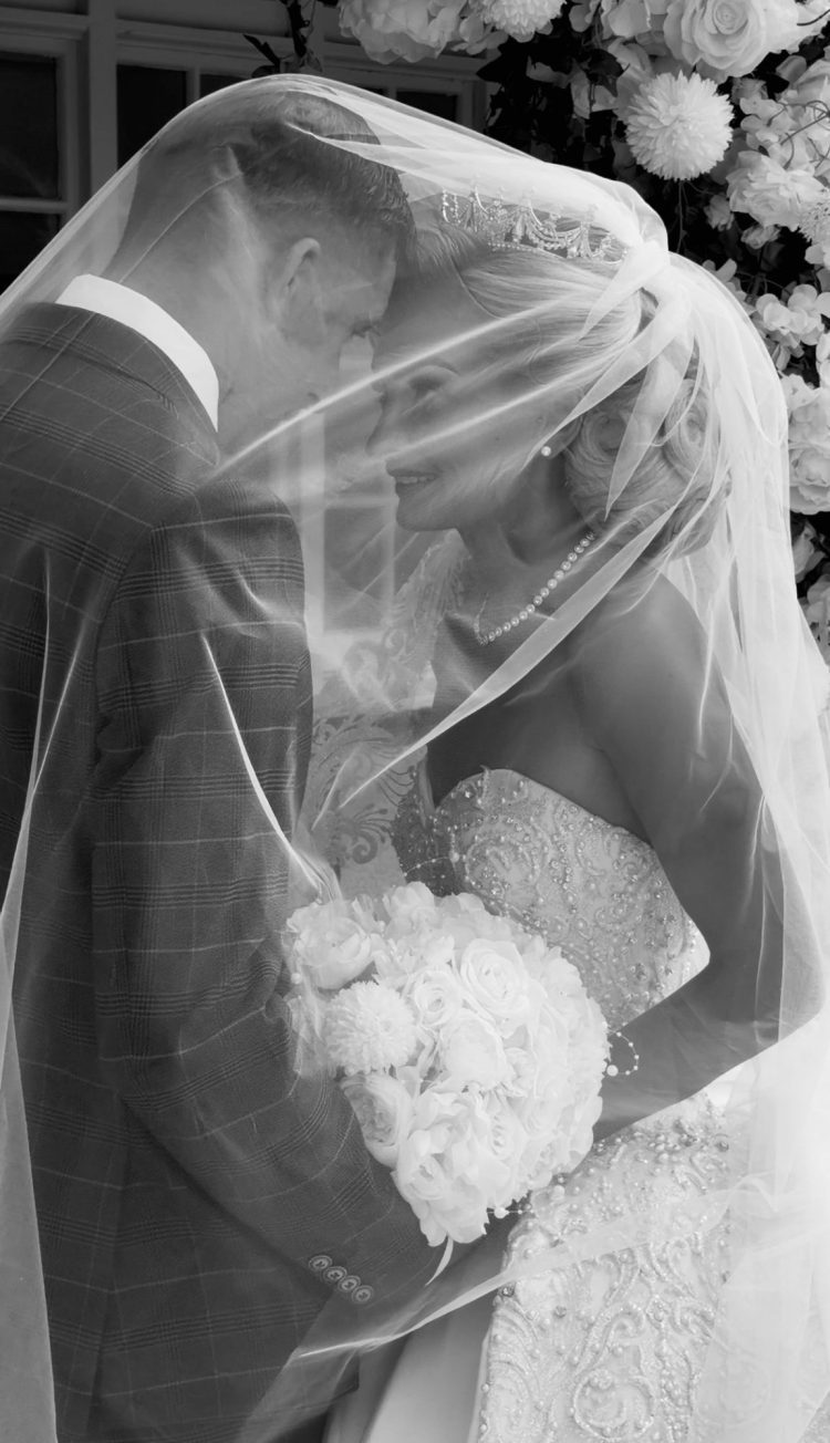 bride and groom with veil