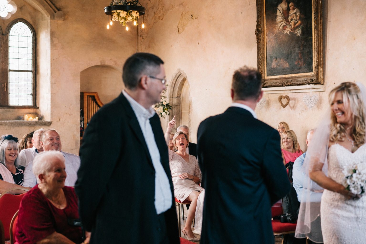 candid guests laugh during ceremony