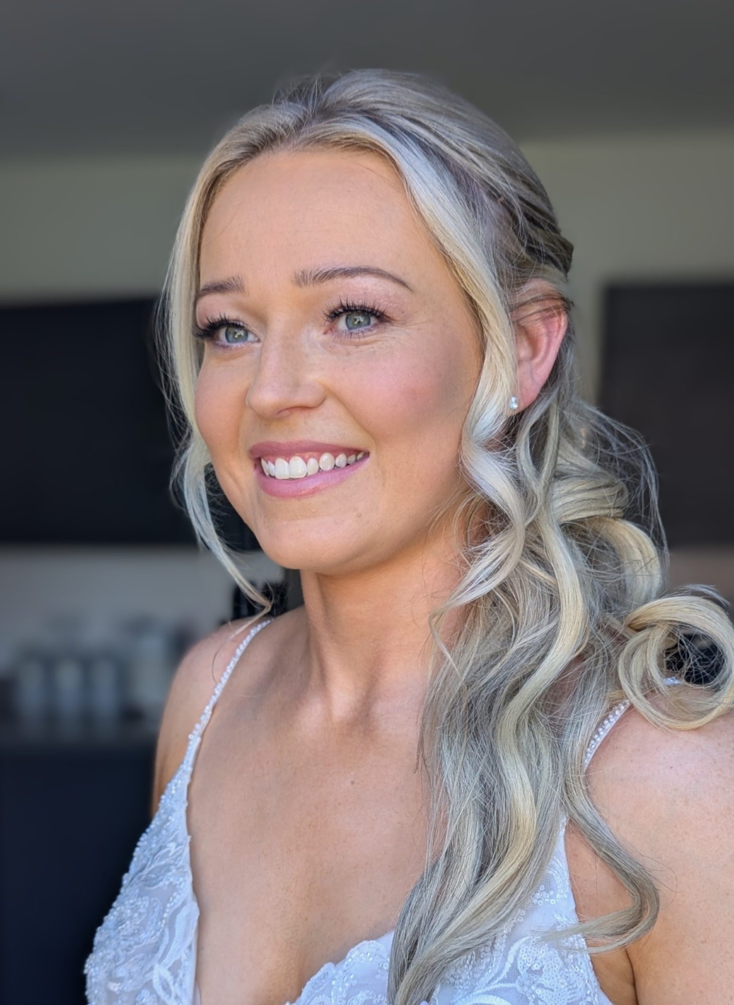 A stunning half up hair style with soft curls and a radiant natural make-up